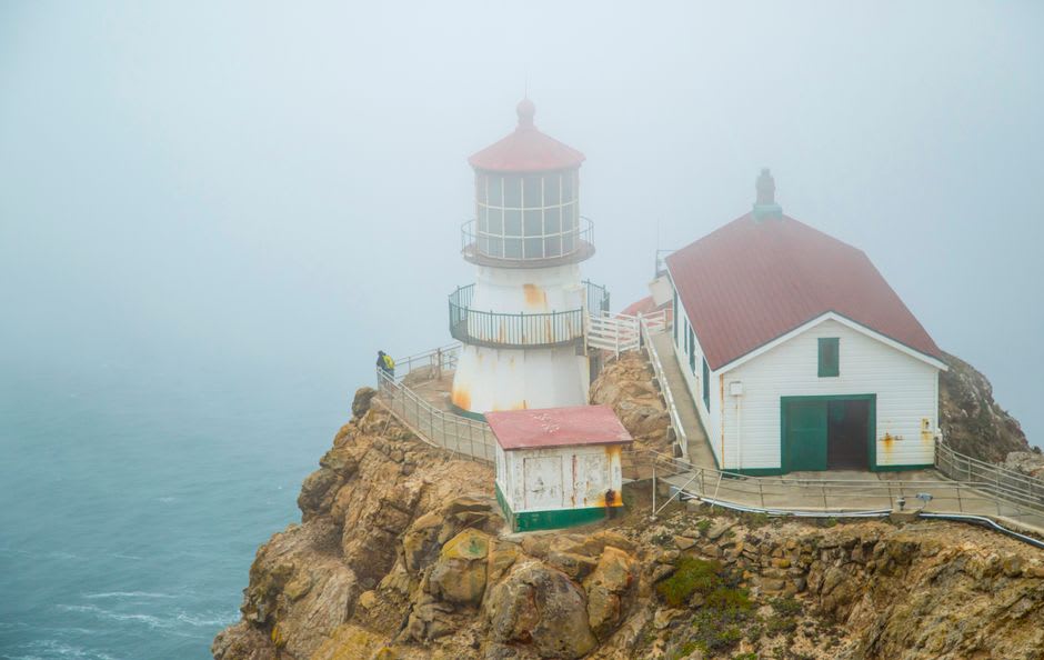 The long staircase descending toward the small iron Point Reyes Lighthouse on its wind-battered cliff