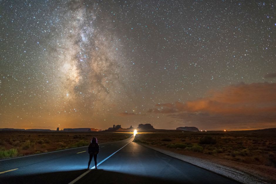 Stars filling the dark desert sky above the flat highway near Rachel, Nevada