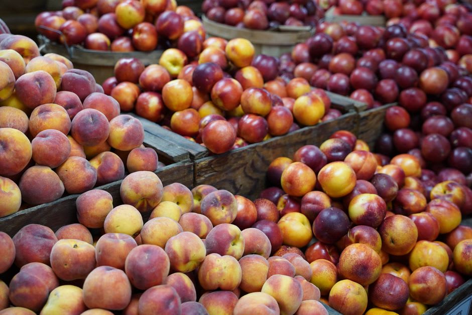 A wooden crate of ripe peaches at a farm stand near Ruston, Louisiana