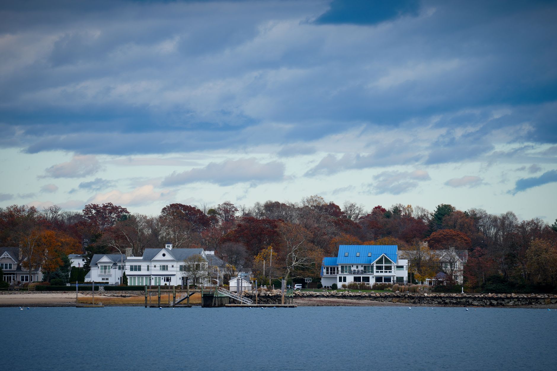Sailboats moored in Sag Harbor's working marina with Main Street rooftops behind