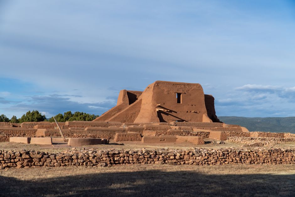 The adobe galleries and garden sculptures lining Canyon Road in Santa Fe in golden afternoon light