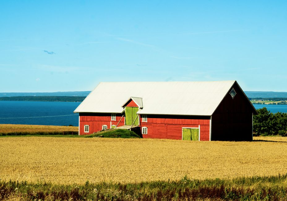 Shelburne Farms' Romanesque dairy barn with Lake Champlain and the Adirondacks beyond