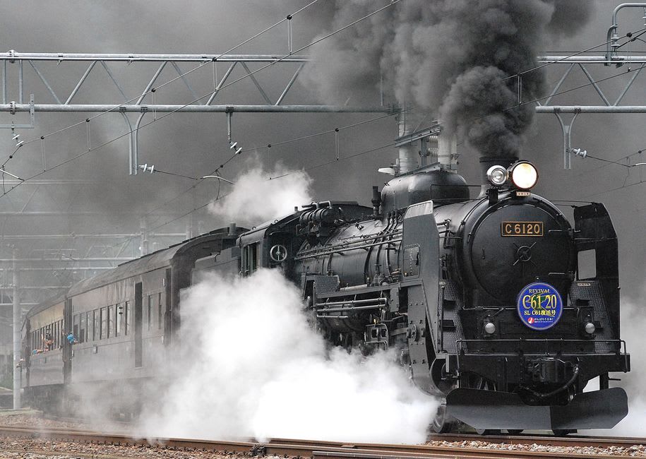 A restored wooden passenger coach on the Strasburg Rail Road passing Amish farmland in Strasburg, Pennsylvania