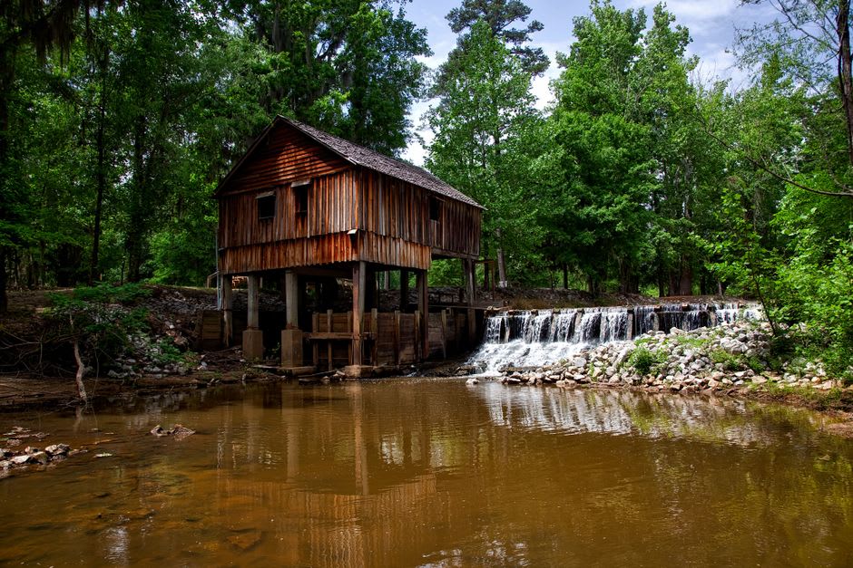 A reconstructed nineteenth-century wooden oil derrick standing over Oil Creek at the Drake Well site in Titusville, Pennsylvania