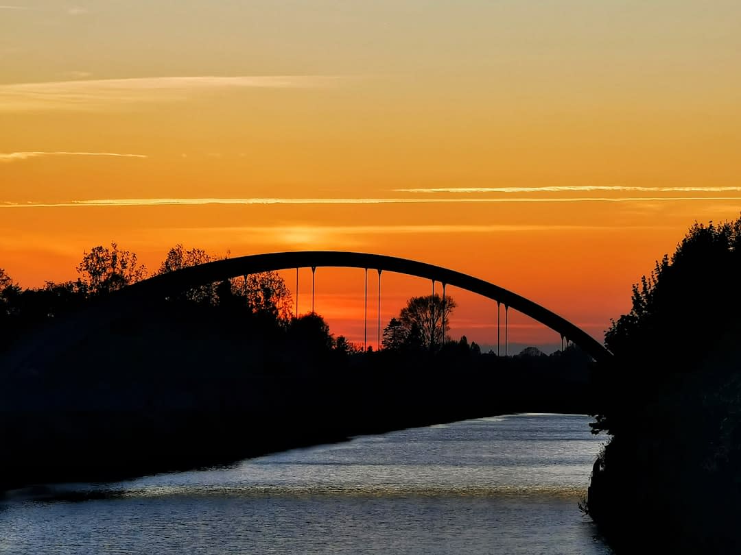 The Hi-Line railroad trestle bridge glowing at dusk above the Sheyenne River in Valley City, North Dakota