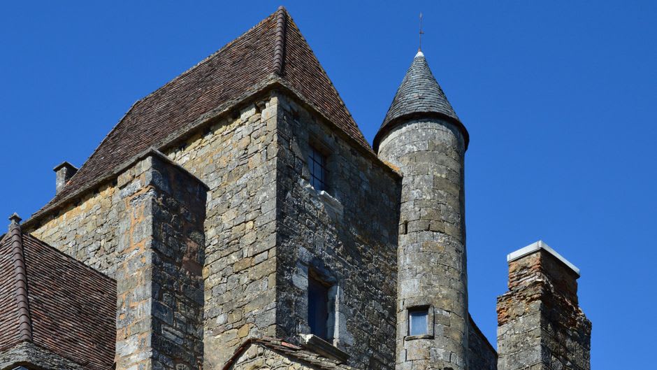A turreted stone castle rising unexpectedly from bluegrass farmland near Versailles, Kentucky