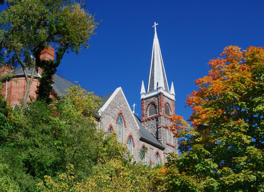 The stone facade and steeple of the Old Cathedral parish church in Vincennes, Indiana