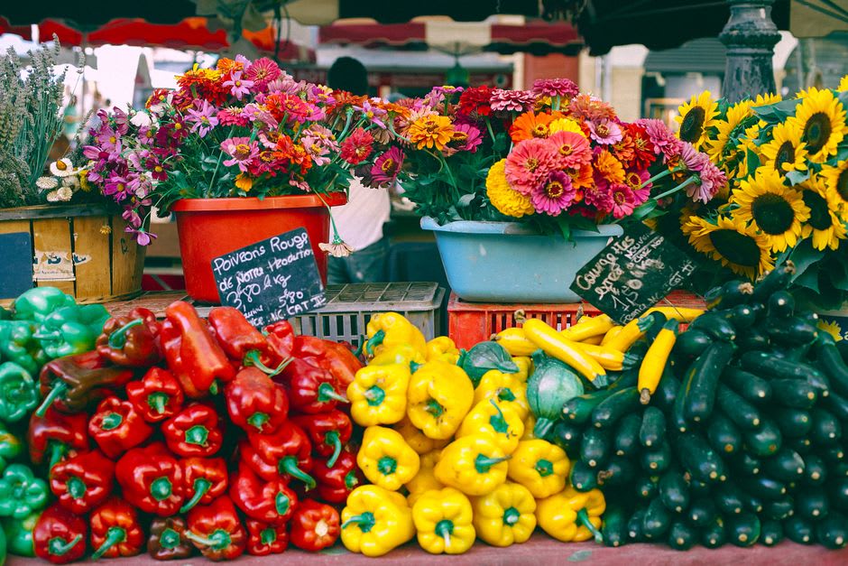A farmers market stall with fresh produce and flowers on the green in Wakefield, Rhode Island