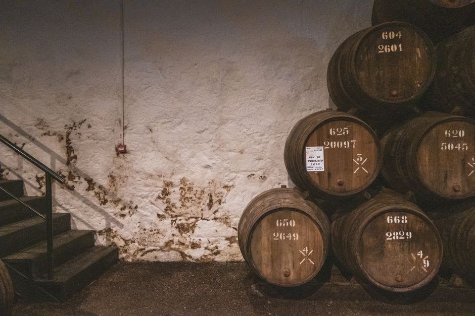 Rows of aging bourbon barrels in the limestone cellars of the historic McCormick Distillery in Weston, Missouri