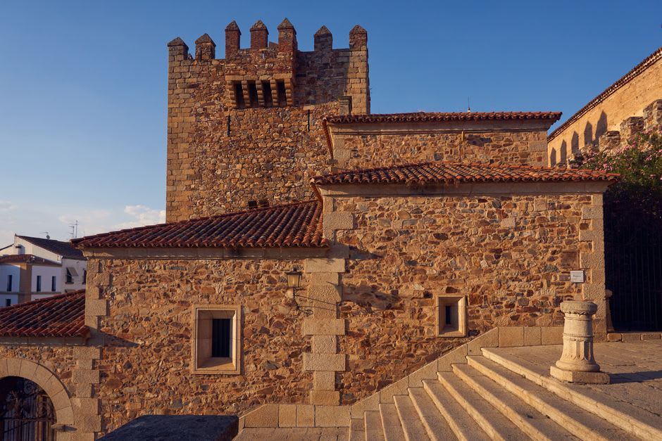 The eclectic turrets and stone facade of Castillo de Piria at golden hour