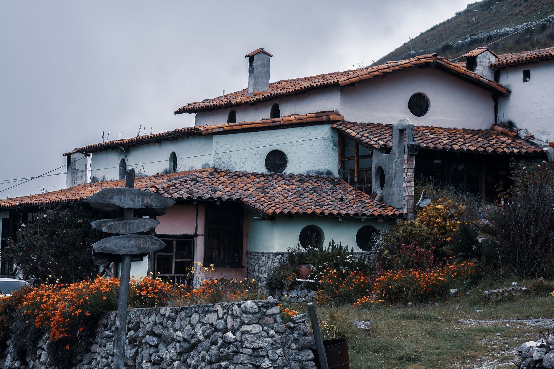 A timber-framed church and houses emerging from mountain mist
