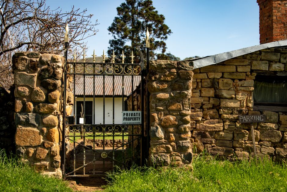 The preserved garden and heritage house at Buda Historic Home in Castlemaine, with mature trees and period plantings
