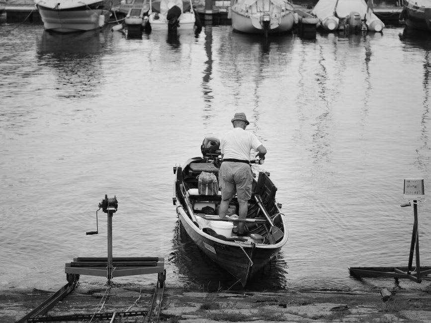 Weatherboard fishing cottages and moored boats along the Moyne River in Port Fairy