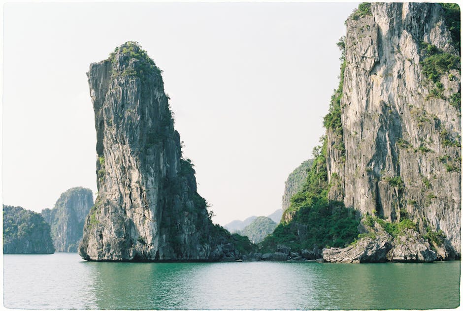 Towering limestone islands in Ha Long Bay under clear skies