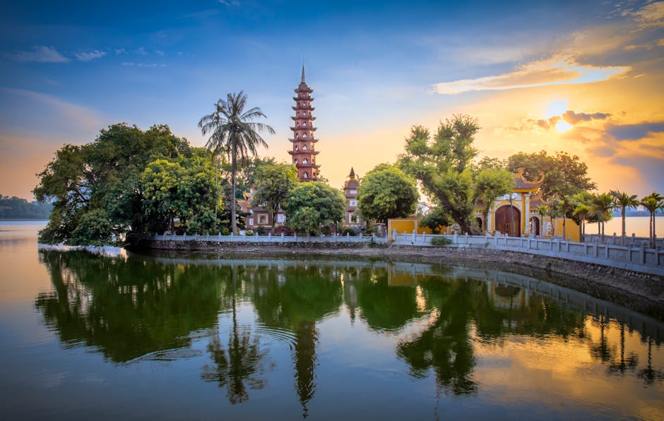 Stunning sunset view of Tran Quoc Pagoda reflecting on West Lake, Hanoi