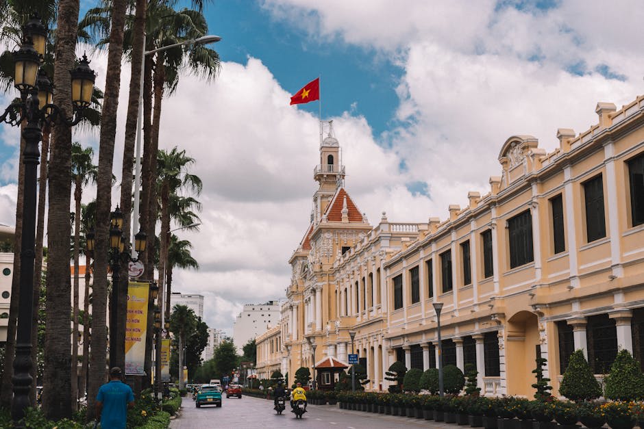Charming street view of Ho Chi Minh City Hall with Vietnamese flag