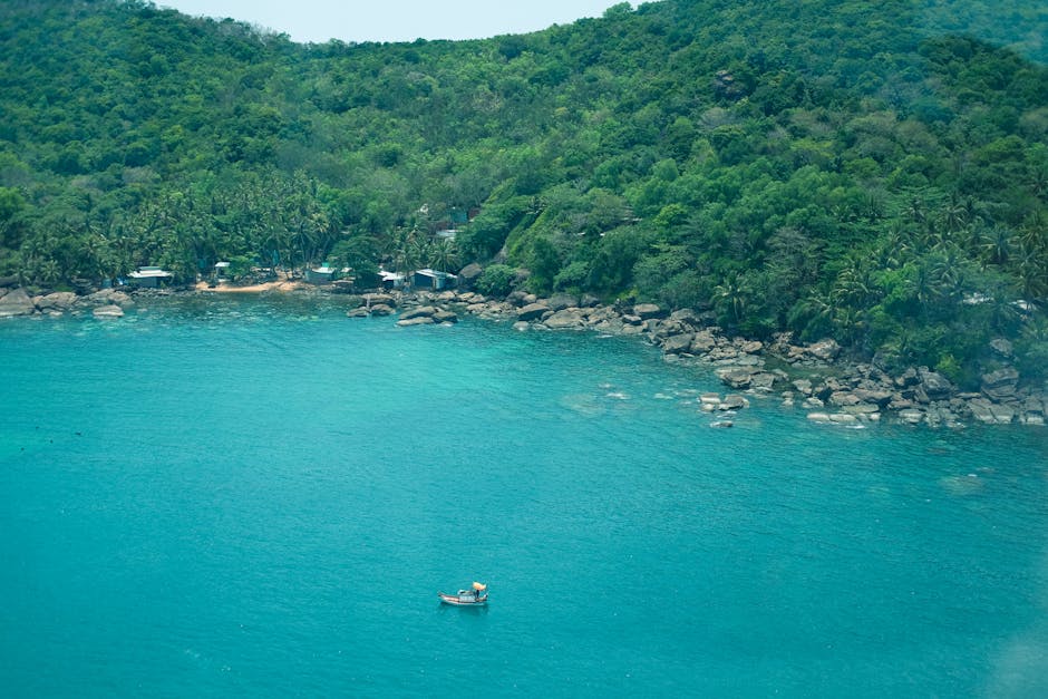 A picturesque aerial view of Phu Quoc island's tropical coastline with lush forests and clear ocean