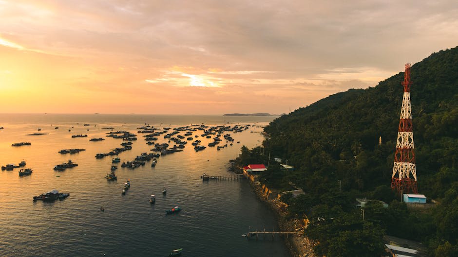 Aerial view of a tranquil fishing village in Phu Quoc at sunset with vibrant skies and calm waters