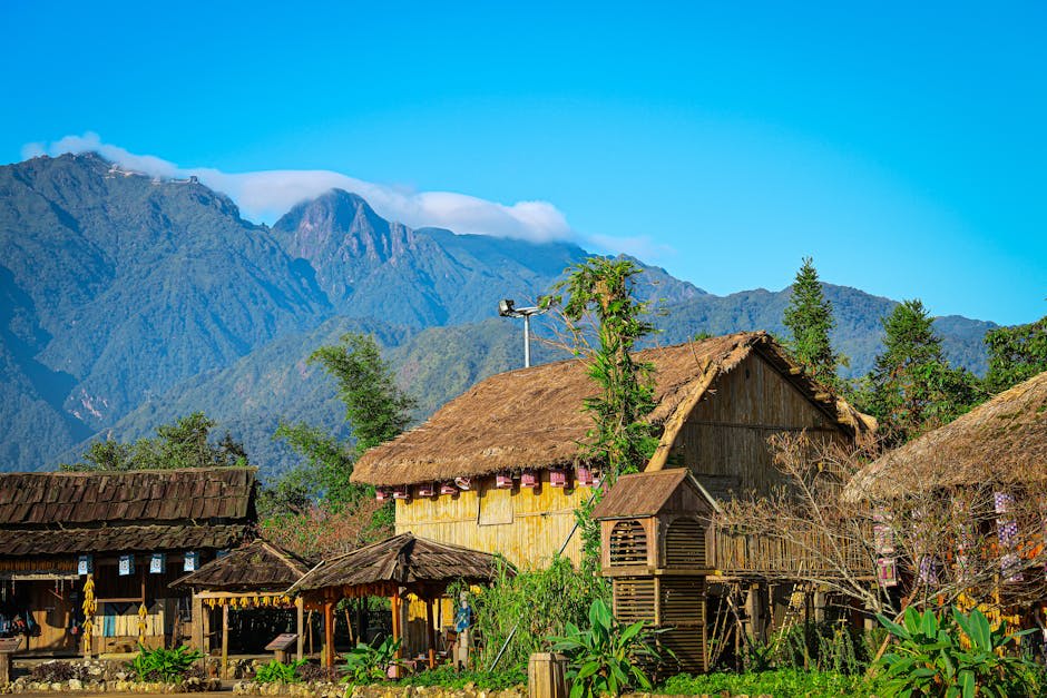 Scenic view of traditional thatched houses with mountains in Sapa