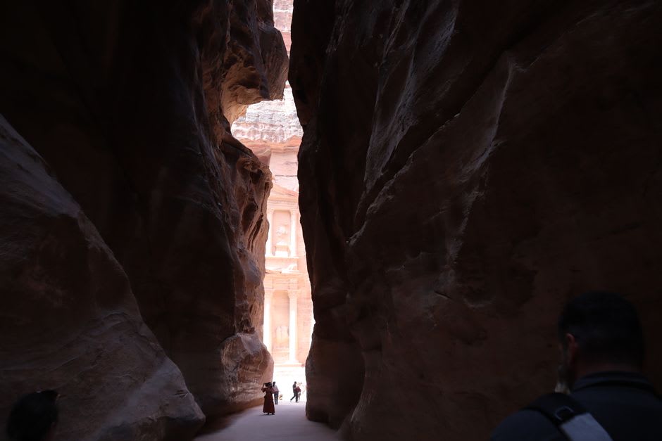 Narrow rock passage between towering canyon walls in Barrah Canyon, Wadi Rum