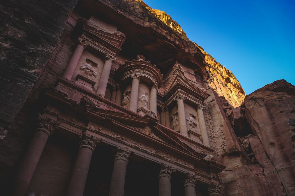 Golden late-afternoon light over the ruined podium of the Temple of Allat with Jebel Rum in the background