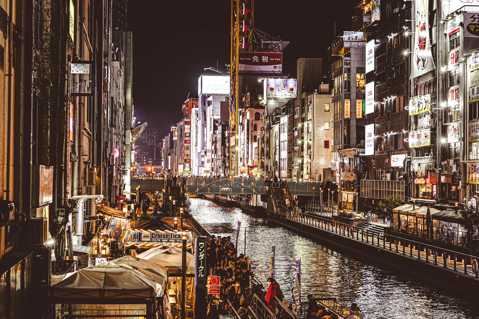 Dotonbori canal at night with neon signs reflected in the water