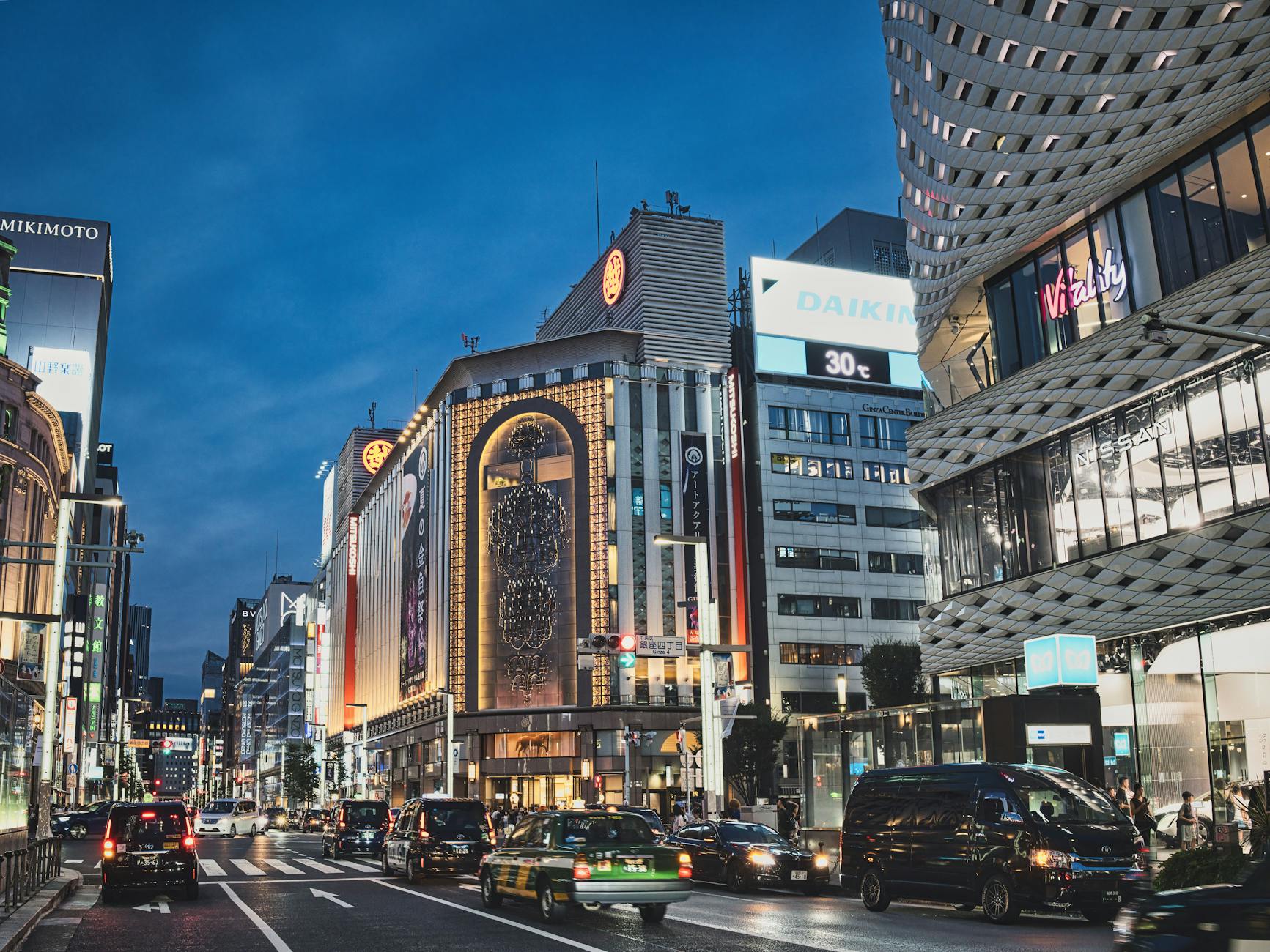 Ginza district in Tokyo with illuminated luxury storefronts at night