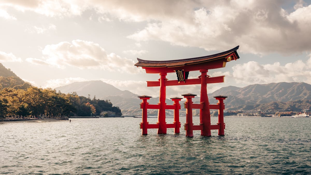 A traditional Japanese temple gate framed by autumn foliage — one of the twenty days in the full guide