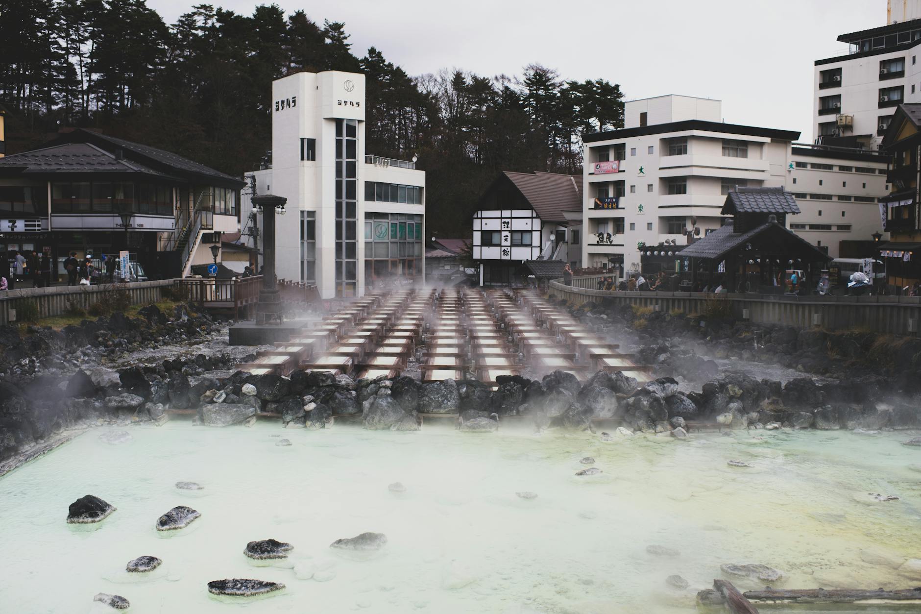 Traditional Japanese onsen bath with steam rising in a serene ryokan setting