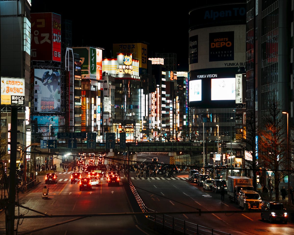 Neon-lit streets of Tokyo at night with bright signs and crowds