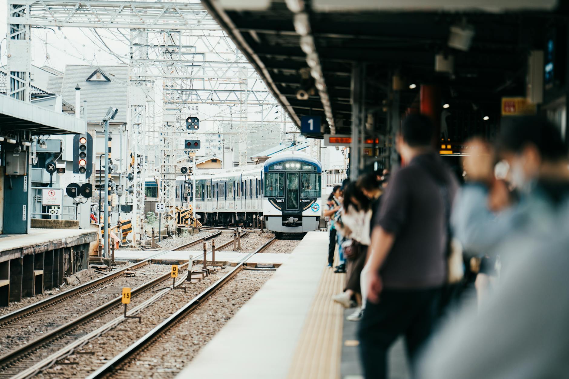 Sleek Japanese bullet train at a platform with passengers boarding