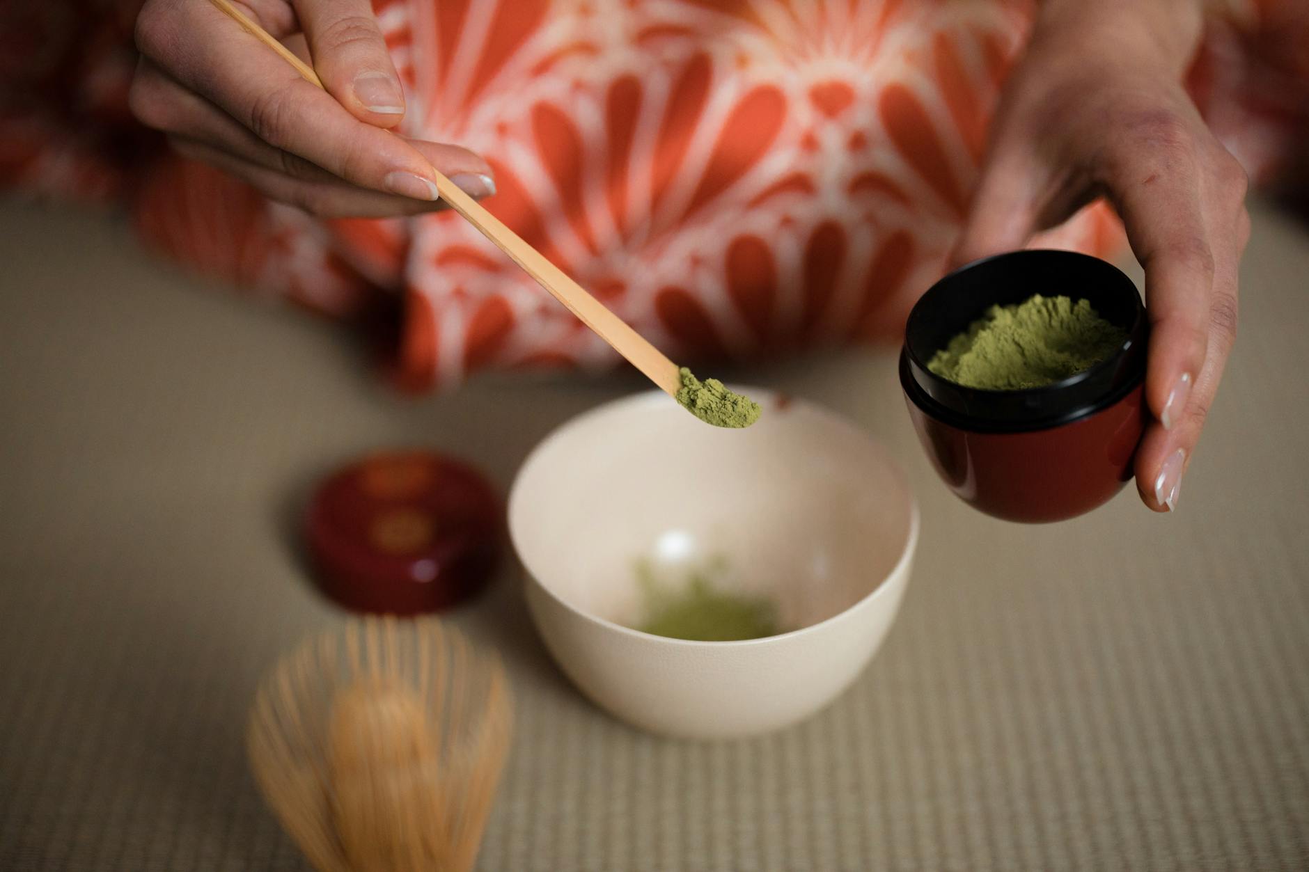 Traditional Japanese matcha tea ceremony with a ceramic bowl and whisk