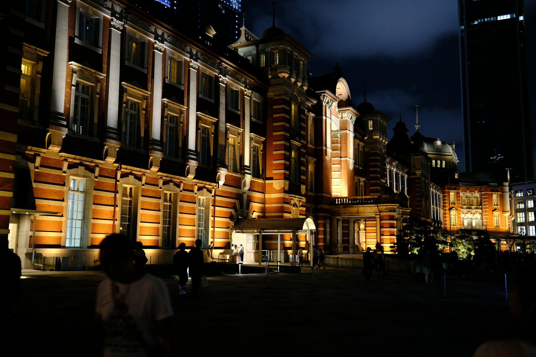 The grand red-brick facade of Tokyo Station at twilight