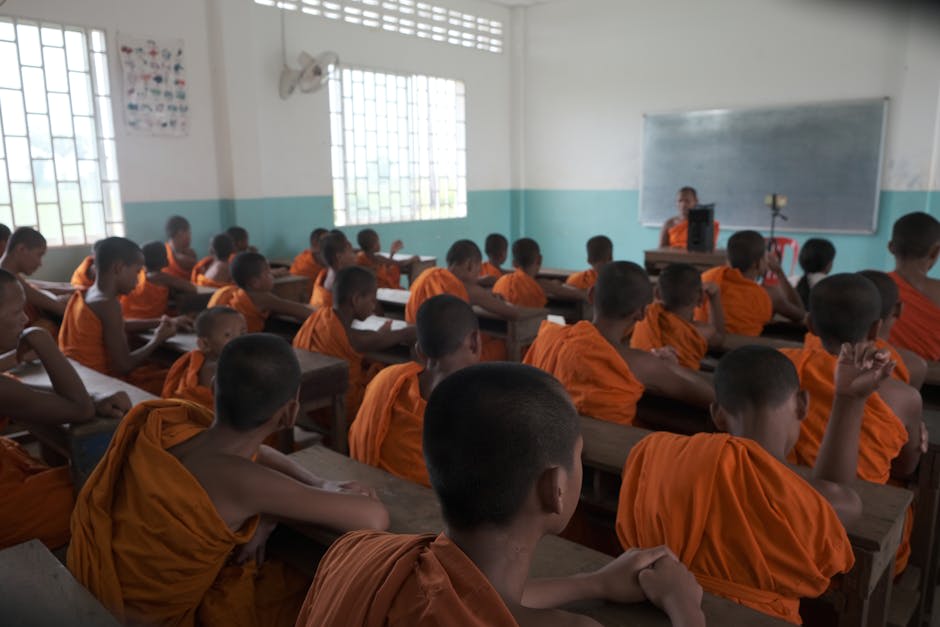 Monks in saffron robes walking through an ancient Cambodian temple