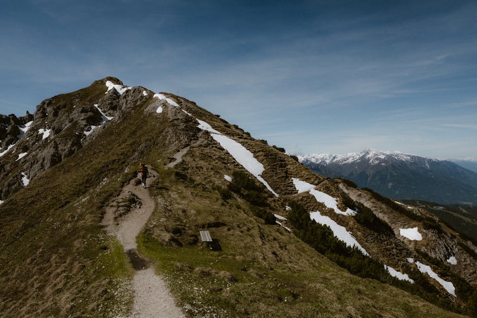Alpine wilderness with snow-dusted peaks under dramatic skies