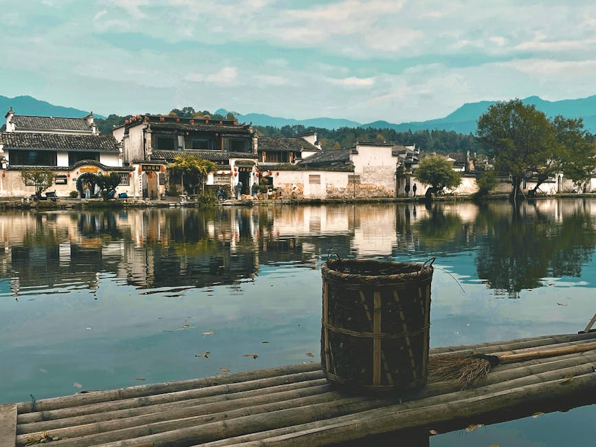 A rural Chinese landscape with green hills and misty valleys