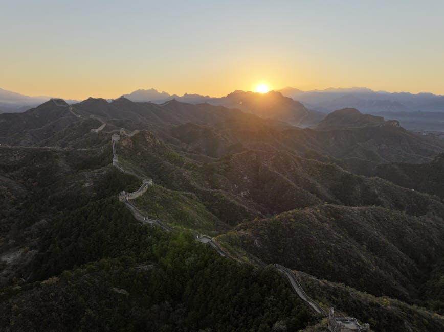 The Great Wall stretching across mountain ridgelines at sunrise