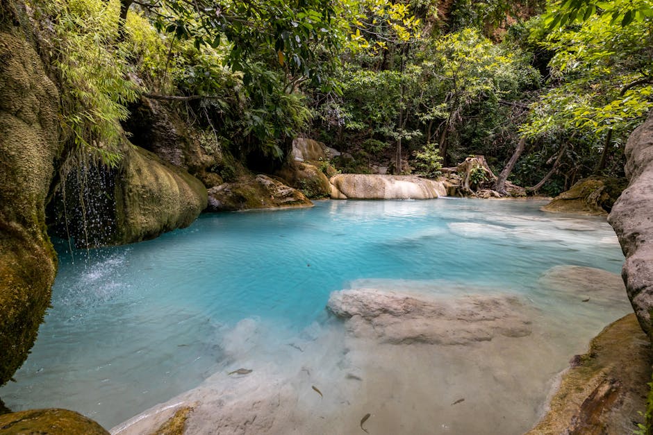Lush tropical waterfall surrounded by dense jungle vegetation