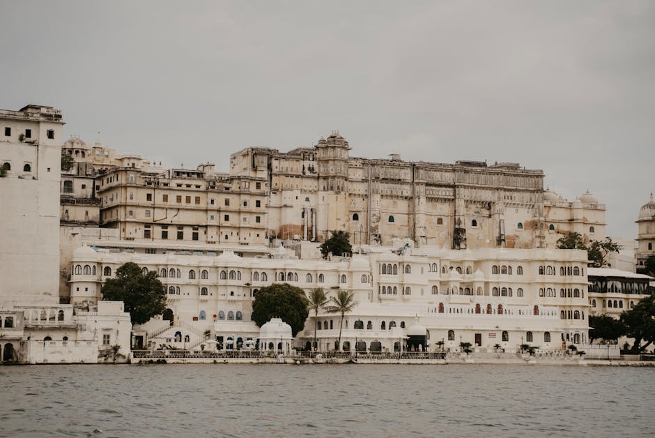 The white marble Lake Palace reflected in the still waters of Lake Pichola at sunset