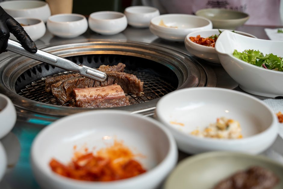 Sizzling Korean barbecue with side dishes on a table