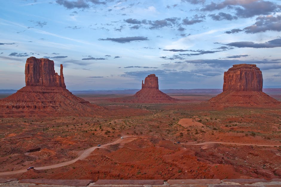 Monument Valley buttes rising from the desert floor in amber light