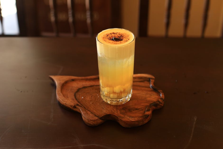 A delicious glass of Vietnamese egg coffee served on a wooden tray