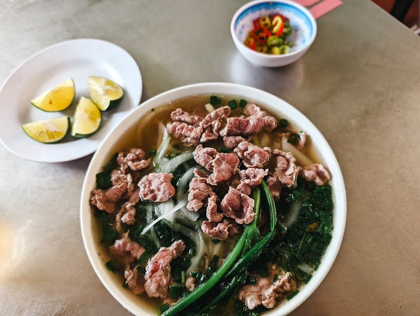 A vibrant street food scene in Hanoi with traditional pho and iced green tea