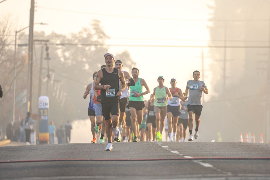 Runners descending the scree slope of Mount Marathon above Seward during the annual race, with the bay visible below