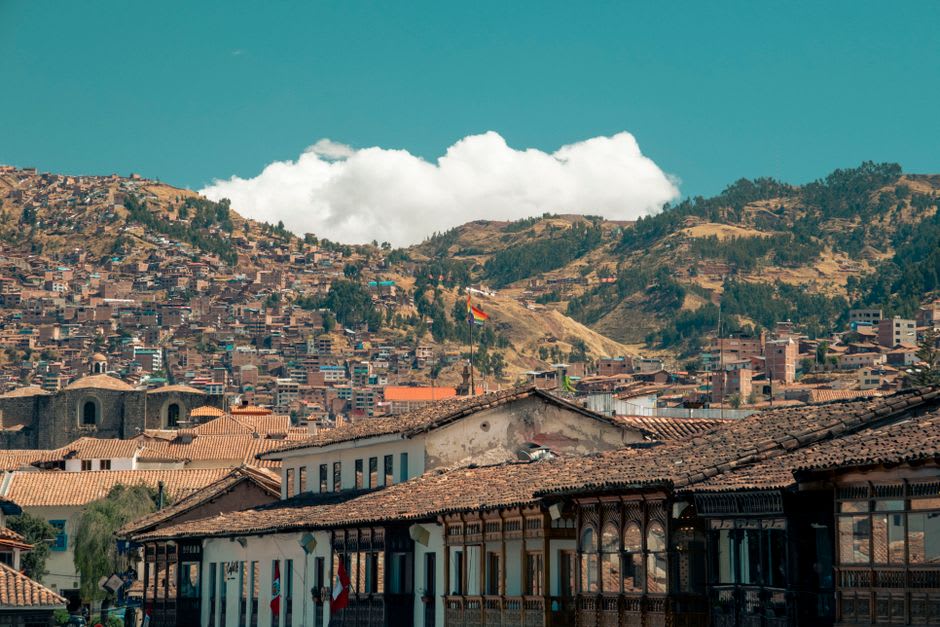 Rooftops of Lamas cascading down the hillside toward the surrounding Amazon rainforest