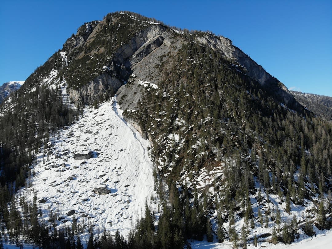 Chairlift rising toward steep rock walls inside the Arcalis glacial cirque