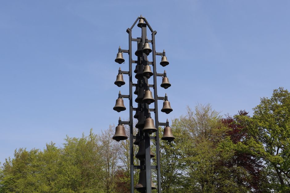 Bronze memorial chimneys with bells standing where village houses once stood at Khatyn