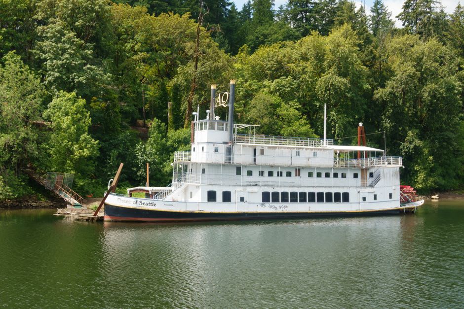 The SS Moyie sternwheeler preserved on the shore of Kootenay Lake, its white hull and paddlewheel visible against the water