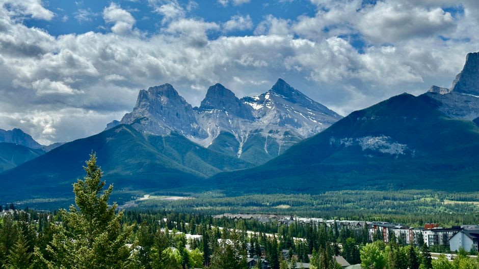 The jagged peaks of the Three Sisters rising above the town of Canmore