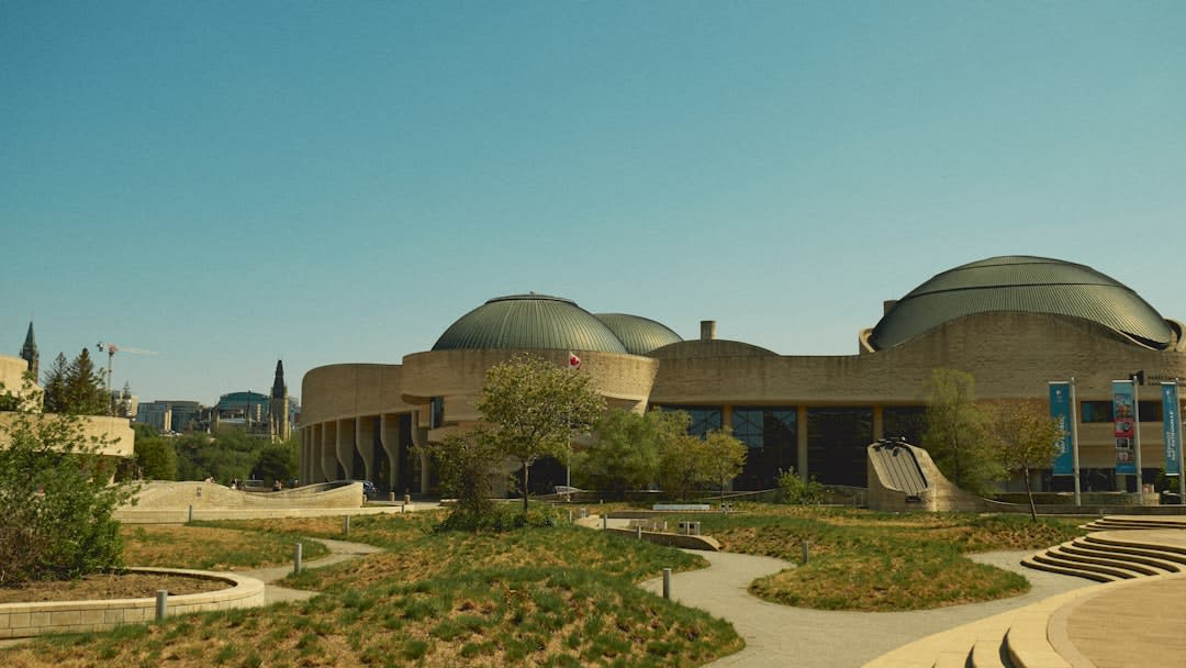 Rammed-earth cultural centre building set among sagebrush and antelope-brush desert scrubland